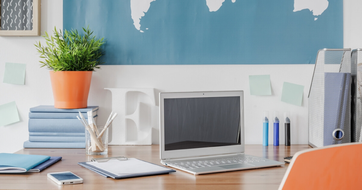 Laptop on clean blue and white desk