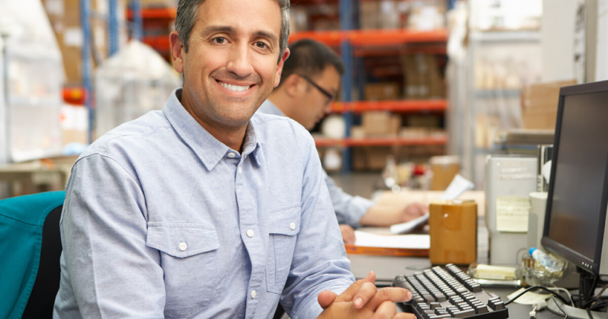 Man smiling at desk